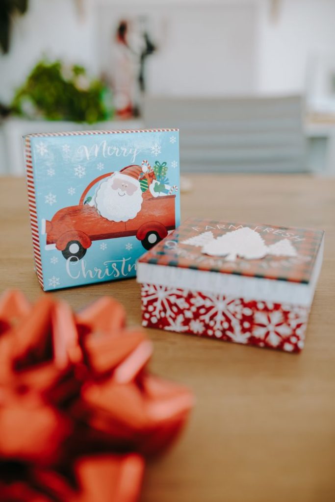 pexels photo 6518981 Colorful Christmas gift boxes with festive decor, perfect for holiday celebrations.